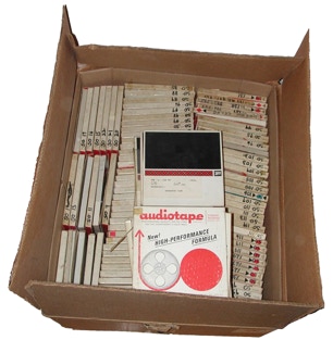 Cardboard box full of reel-to-reel audio tapes